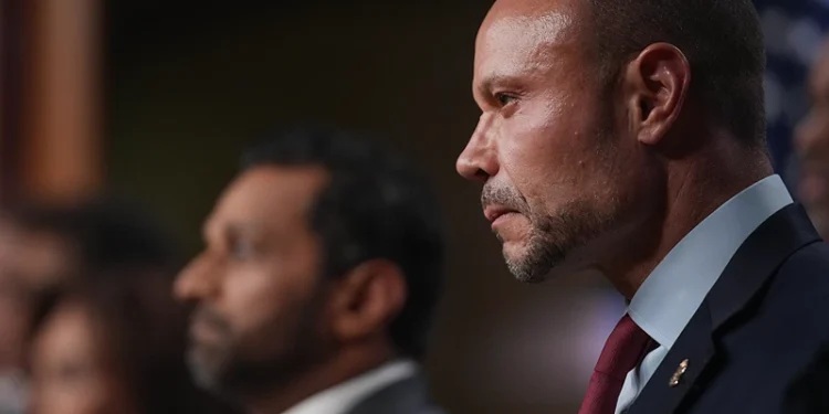 WASHINGTON, DC - DECEMBER 04: Dan Bongino, Deputy Director of the FBI listens to speakers during a news conference about the January 6th pipe bomber at the Department of Justice on December 4, 2025 in Washington, DC. Federal agents have arrested a suspect they are charging with placing two pipe bombs, which never exploded, the night before the January 6th, 2021 U.S. Capitol attack. (Photo by Andrew Harnik/Getty Images)