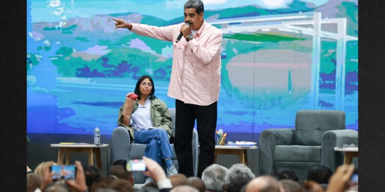Then-Venezuelan President Nicolás Maduro, center, speaks next to Vice President Delcy Rodriguez, left, in a 2024 photo. Since Maduro's Saturday arrest, Rodriguez has issued orders to arrest those who supported the U.S. efforts to capture him.