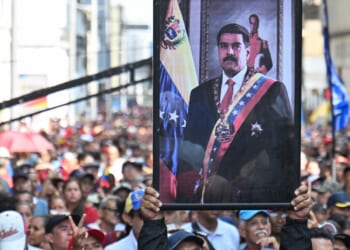 Supporters of ousted Venezuelan President Nicolas Maduro carry his portrait in a rally in Caracas on Jan. 5, 2026.