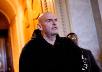 Sen. John Fetterman walks out of the Senate Chamber on Dec. 11, 2025, in Washington, D.C.
