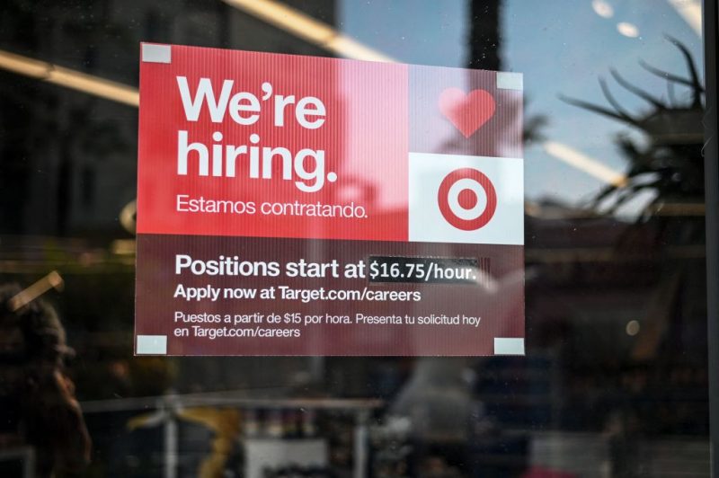 A sign advertising for new employees with an updated starting salary of USD $16.75 per hour is seen in the window of a Target store in Hollywood, California on November 9, 2021. - Even as millions of Americans who lost their jobs to the Covid-19 pandemic have returned to work, companies nationwide report they're still struggling to hire employees in recent months. More than 10 million jobs were unfilled as of the end of August, according to government data. (Photo by Robyn Beck / AFP) (Photo by ROBYN BECK/AFP via Getty Images)