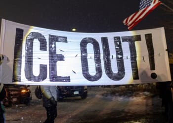 Protesters hold a large anti-ICE sign in Minneapolis, Minnesota on Jan. 18, 2026.