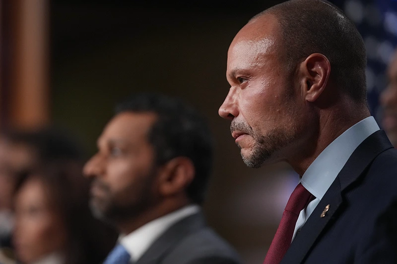 WASHINGTON, DC - DECEMBER 04: Dan Bongino, Deputy Director of the FBI listens to speakers during a news conference about the January 6th pipe bomber at the Department of Justice on December 4, 2025 in Washington, DC. Federal agents have arrested a suspect they are charging with placing two pipe bombs, which never exploded, the night before the January 6th, 2021 U.S. Capitol attack. (Photo by Andrew Harnik/Getty Images)