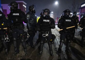 Minneapolis police form a line near so-called "protesters" and anti-ICE agitators in Maple Grove on the outskirts of Minneapolis, Minnesota, on Jan. 26, 2026.