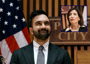 (Background) New York City Mayor Zohran Mamdani attends a news conference at the headquarters of the NYPD on January 06, 2026 in New York City. Mamdani, who was joined by New York Gov. Kathy Hochul and Police Commissioner Jessica Tisch, discussed crime statistics and safety, including a historic drop in shootings in New York City last year. (Photo by Spencer Platt/Getty Images) / (R) New York Governor Kathy Hochul looks on during a public safety-related announcement at the headquarters of the New York City Police Department (NYPD) in New York on January 6, 2026. (Photo by CHARLY TRIBALLEAU / AFP via Getty Images)