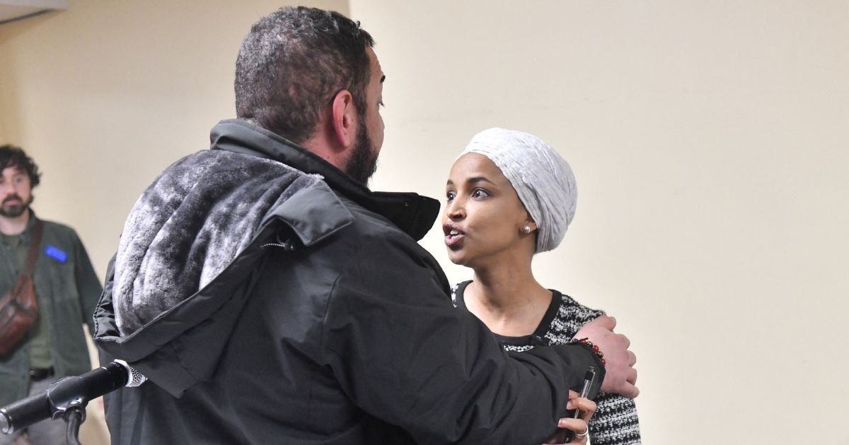 Rep. Ilhan Omar reacts after being sprayed with an unknown substance by a man as she hosted a town hall in Minneapolis, Minnesota, on Jan. 27, 2026.