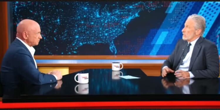 Sen. Mark Kelly, left, went quiet when host Jon Stewart brought up the Obama administration's "extrajudicial killings."