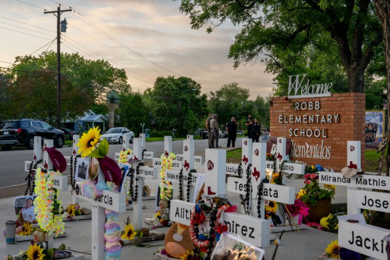 UVALDE, TEXAS - MAY 24: Law enforcement stand watch near a memorial dedicated to the 19 children and two adults murdered on May 24, 2022 during the mass shooting at Robb Elementary School on May 24, 2023 in Uvalde, Texas. Today marks the 1-year anniversary of the mass shooting at the school. 19 children and two teachers were killed when a gunman entered the school, opening fire on students and faculty. (Photo by Brandon Bell/Getty Images)