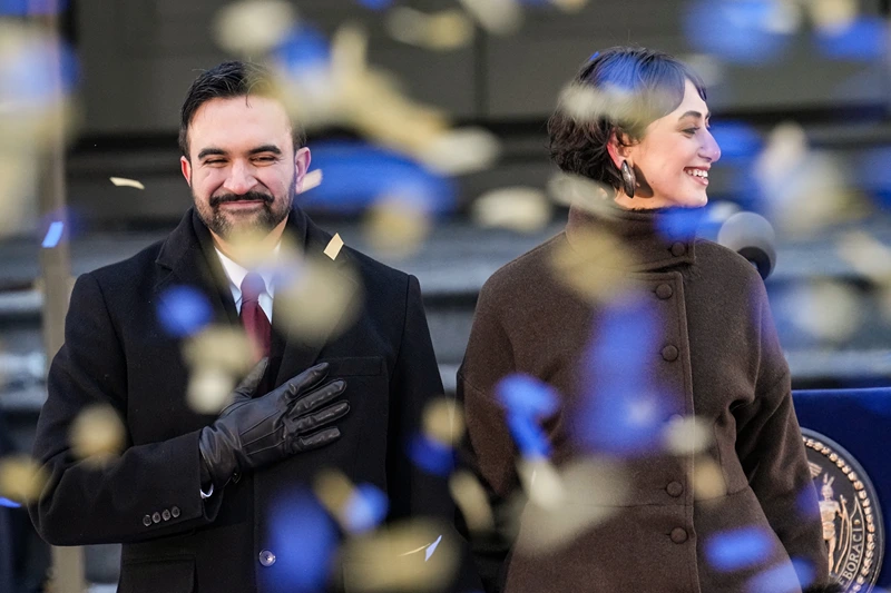 NEW YORK, NEW YORK - JANUARY 01: New York Mayor Zohran Mamdani and his wife Rama Duwaji smile as confetti falls after his ceremonial inauguration as mayor at City Hall Thursday January 1, 2026 in New York, NY. Mamdani has added a “block party” to the official inauguration events to allow thousands of New Yorkers to take part. Mamdani was officially sworn in at midnight by New York Attorney General Letitia James at the Old City Hall subway station in a private ceremony. (Photo by David Dee Delgado/Getty Images)