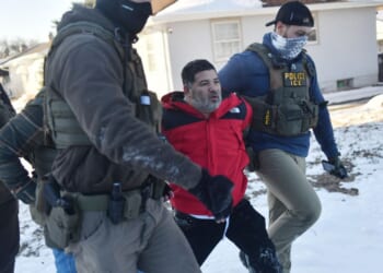 Federal immigration agents detain a man during an operation by Immigration and Customs Enforcement and Border Patrol in St. Paul, Minnesota, on Jan. 27, 2026.