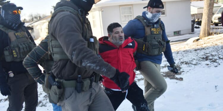 Federal immigration agents detain a man during an operation by Immigration and Customs Enforcement and Border Patrol in St. Paul, Minnesota, on Jan. 27, 2026.