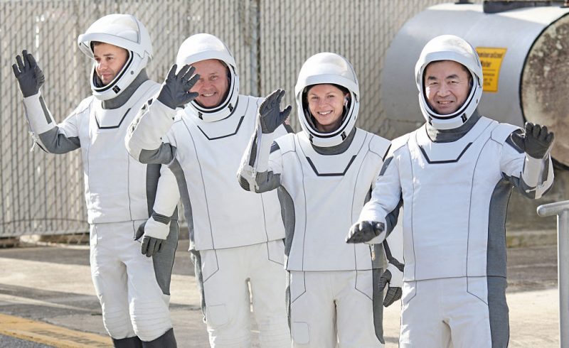 Crew-11 mission astronauts wave as they depart the Neil A. Armstrong Operations and Checkout Building en route to launch complex LC-39A at the Kennedy Space Center in Cape Canaveral, Florida on August 1, 2025. From L/R are Roscosmos cosmonaut Oleg Platonov, NASA astronaut Mike Fincke, NASA astronaut and mission commander Zena Cardman and JAXA astronaut Kimiya Yui. The crew will live and work aboard the International Space Station for at least six months. (Photo by Gregg Newton / AFP) (Photo by GREGG NEWTON/AFP via Getty Images)