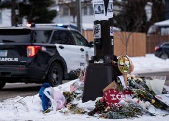 A Minneapolis police vehicle is parked near a memorial for anti-ICE protester Renee Good who was shot to death Jan. 7 while confronting Immigration and Customs Enforcement behind the wheel of her vehicle.