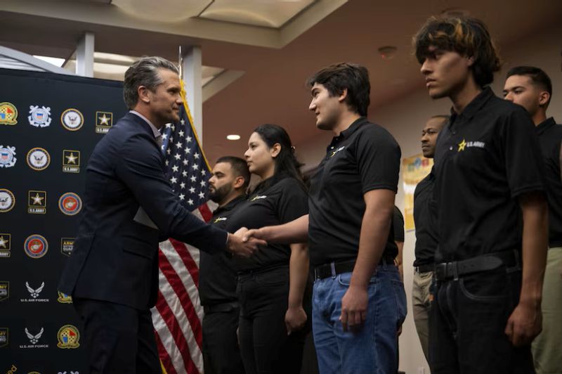 War Secretary Pete Hegseth greets recruits at a swearing-in ceremony at the Los Angeles Military Entrance Processing Station on January 9, 2026. (via: U.S. Department of War)