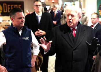 President Donald Trump speaks to guests alongside GOP Rep. Zach Nunn of Iowa, left, as he visits the Machine Shed restaurant Tuesday in Urbandale, Iowa.