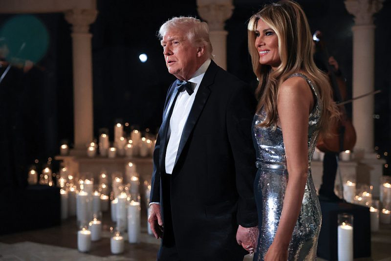 PALM BEACH, FLORIDA - DECEMBER 31: U.S. President Donald Trump and first lady Melania Trump arrive for a New Year’s Eve event at his Mar-a-Lago home on December 31, 2025 in Palm Beach, Florida. The president addressed guests and celebrated the arrival of 2026. (Photo by Joe Raedle/Getty Images)