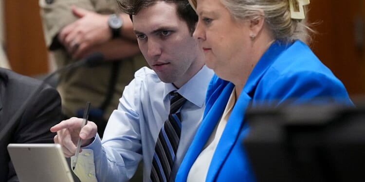 PROVO, UTAH - JANUARY 16: Tyler Robinson, left, accused in the fatal shooting of Charlie Kirk, points with defense attorney Kathryn Nester during a hearing in 4th District Court on January 16, 2026 in Provo, Utah. Prosecutors have charged Tyler Robinson with aggravated murder and plan to seek the death penalty. (Photo by Bethany Baker-Pool/Getty Images)