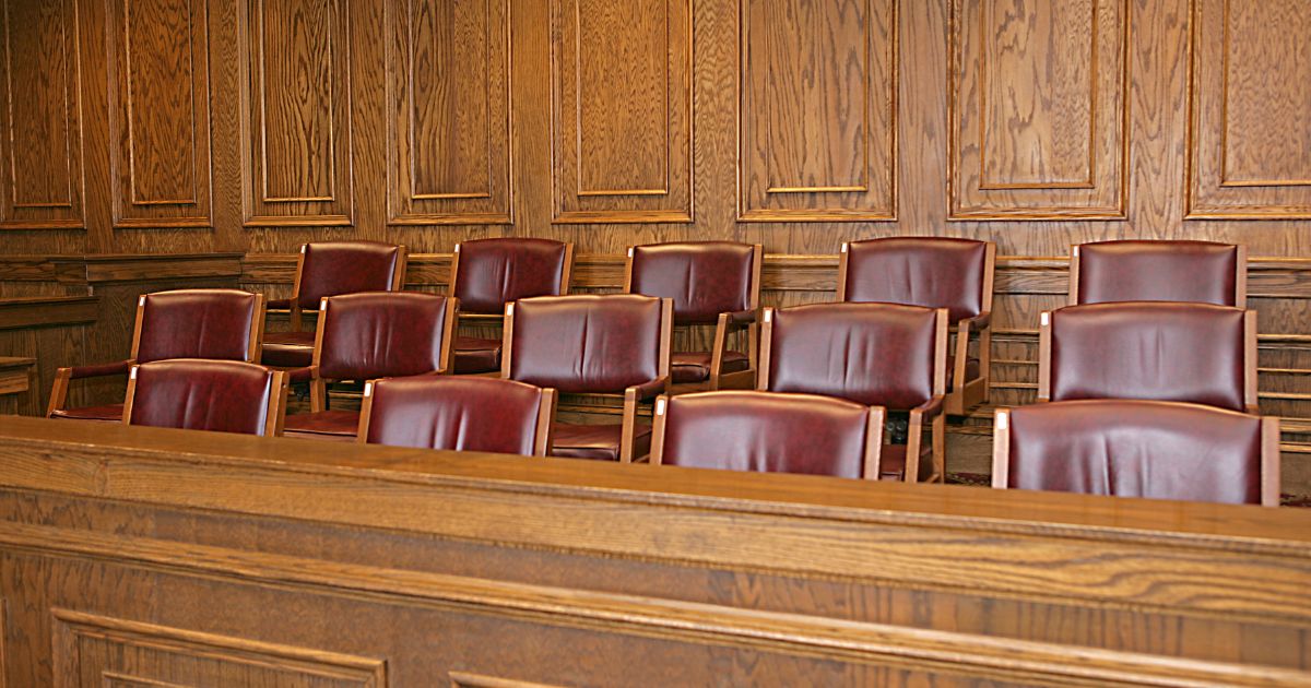 A jury box sits in a courthouse's courtroom.