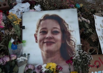 A picture of Renee Good is covered with flowers at a memorial on Jan. 29, 2026, in Minneapolis, Minnesota.
