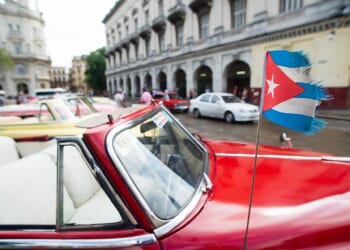 Frayed Cuban flag on car.