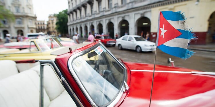 Frayed Cuban flag on car.