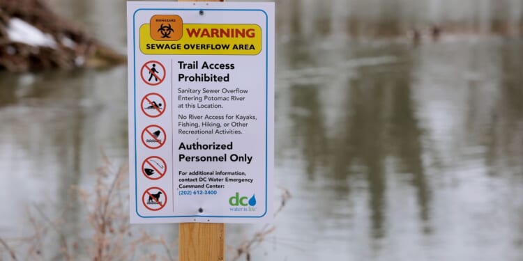 A notice alerting of a sewage overflow area is posted along the Potomac River Thursday in Cabin John, Maryland. This week District of Columbia Mayor Muriel Bowser declared a public emergency for the sewage spill in the Potomac River, 30 days after a section of a major pipe collapsed, unleashing millions of gallons of untreated sewage into the river.