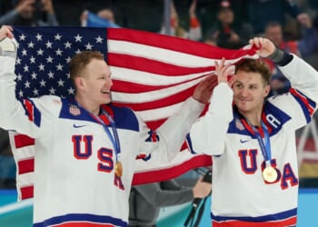 Brady Tkachuk #7 and Matthew Tkachuk #19 of Team United States celebrate their gold-medal win Sunday after the Men's Gold Medal match between Canada and the United States on day 16 of the Milano Cortina 2026 Winter Olympic games in Milan, Italy.