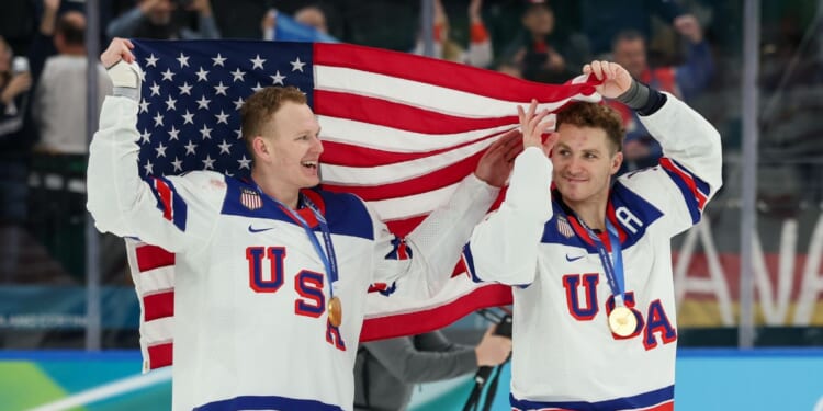 Brady Tkachuk #7 and Matthew Tkachuk #19 of Team United States celebrate their gold-medal win Sunday after the Men's Gold Medal match between Canada and the United States on day 16 of the Milano Cortina 2026 Winter Olympic games in Milan, Italy.