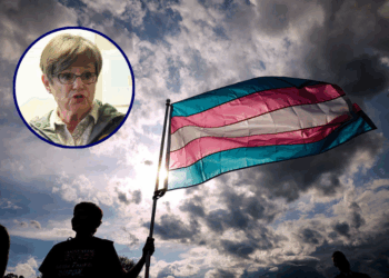 (Background) A transgender rights activist holds a flag during the Trans Day Of Visibility rally on the National Mall on March 31, 2025 in Washington City. Trans, non-binary, and gender-expansive people and supporters took part in rallies around the country to fight for trans rights and equality on International Transgender Day of Visibility. (Photo by Kayla Bartkowski/Getty Images) / (L) Incumbent Democratic Kansas Gov. Laura Kelly speaks to volunteers and supporters during a "Get Out The Vote" canvassing event at Shawnee County Democrats office on November 7, 2022 in Topeka, Kansas. Kelly faces Republican state Attorney General Derek Schmidt in her reelection bid on Tuesday. (Photo by Michael B. Thomas/Getty Images)