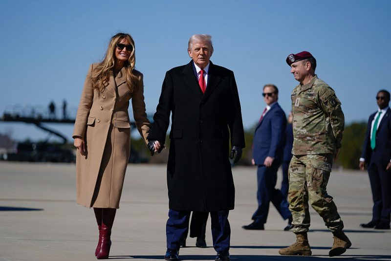 FORT BRAGG, NORTH CAROLINA - FEBRUARY 13: U.S. President Donald Trump and first lady Melania Trump walk from Air Force One after landing at Pope Army Airfield for a visit to the Fort Bragg U.S. Army base on February 13, 2026 in Fort Bragg, North Carolina. Trump visited the base to honor special forces involved in the military operation in Venezuela in early 2026. (Photo by Nathan Howard/Getty Images)