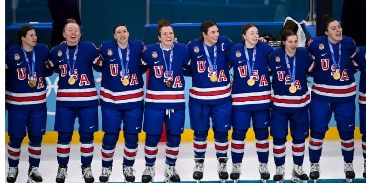 Gold medalist Team United States celebrates Thursday during a medal ceremony after the Women's Gold Medal match between the United States and Canada on day 13 of the Milano Cortina 2026 Winter Olympic games in Milan, Italy.