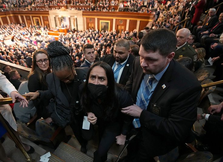 WASHINGTON, DC - FEBRUARY 24: Aliya Rahman, a guest of Rep. Ilan Omar (D- MN) and a Minneapolis resident who was detained by DHS agents, is escorted from the chamber as Trump delivers his State of the Union address during a Joint Session of Congress at the U.S. Capitol on February 24, 2026, in Washington, DC. Trump delivered his address days after the Supreme Court struck down the administration's tariff strategy and amid a U.S. military buildup in the Persian Gulf threatening Iran. (Photo by Andrew Harnik/Getty Images)