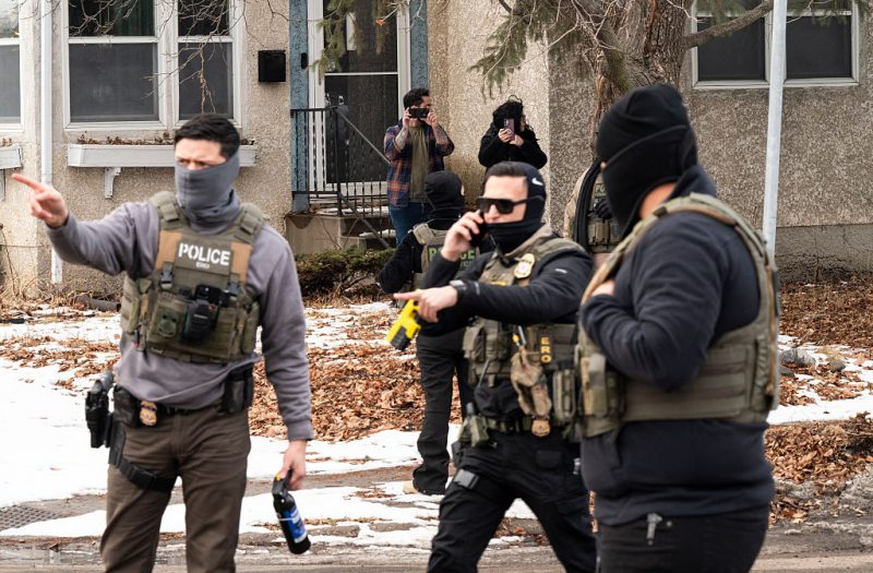 MINNEAPOLIS, MINNESOTA - FEBRUARY 05: Observers film ICE agents as they hold a perimeter after one of their vehicles got a flat tire on Penn Avenue on February 5, 2026 in Minneapolis, Minnesota. Protests continue calling for an end to immigration raids in the Twin cities which have already resulted in the fatal shooting deaths of Alex Pretti, a VA nurse, and Renee Good, a mother of three, by federal agents. (Photo by Stephen Maturen/Getty Images)