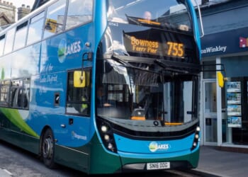 A bus drives down the street in Windermere, Cumbria, UK on March 7, 2023.
