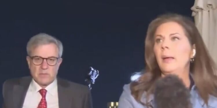 CNN's Erin Burnett, right, heads for cover with Dan Diker, president of the Jerusalem Center for Public Affairs, left, after air raid sirens went off in Tel Aviv, Israel.