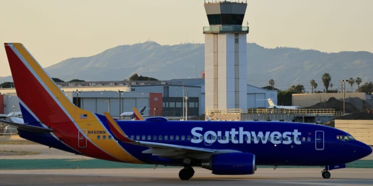 A Southwest Airlines plane taxis near the air traffic control tower at Hollywood Burbank Airport on Jan. 29, 2026, in Burbank, California.