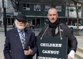 Canadian educator Barry Neufeld of Chilliwack, British Columbia, who faces a $750,000 fine for disagreeing with gender ideology, stands next to activist Billboard Chris.