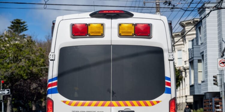 The rear view of a Medstar ambulance van on a city street with traffic signs and overhead wires visible in San Francisco, California, on Feb. 19, 2026.