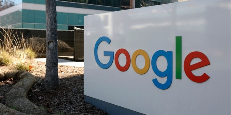 A sign is posted at Google headquarters in Mountain View, California. Three Iranian immigrants have been accused of conspiring to commit trade secret theft from Google and other leading technology companies.