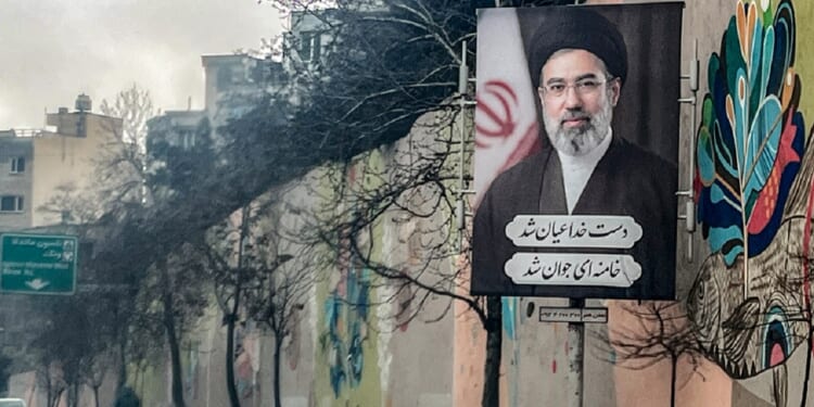 A banner depicting Iran's new Supreme Leader Ayatollah Mojtaba Khamenei is displayed on the side of a highway in Tehran on March 10.