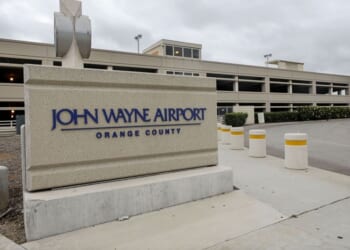 SANTA ANA, CALIFORNIA - JUNE 28: A sign is displayed at John Wayne Airport, located in Orange County, on June 28, 2020 in Santa Ana, California. Orange County Democrats are calling for the name of the airport to be changed due to the deceased actor