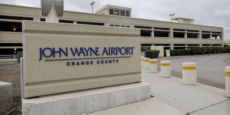 SANTA ANA, CALIFORNIA - JUNE 28: A sign is displayed at John Wayne Airport, located in Orange County, on June 28, 2020 in Santa Ana, California. Orange County Democrats are calling for the name of the airport to be changed due to the deceased actor