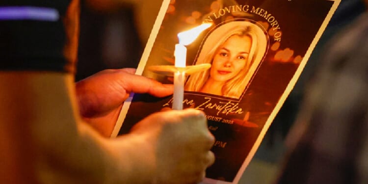 An image of murder victim Iryna Zarutska is pictured on a pamphlet at a vigil in her honor in September in Charlotte, North Carolina.