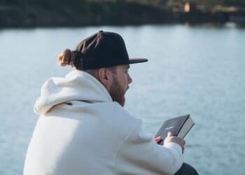 A Christian man holds a Bible in his hands.