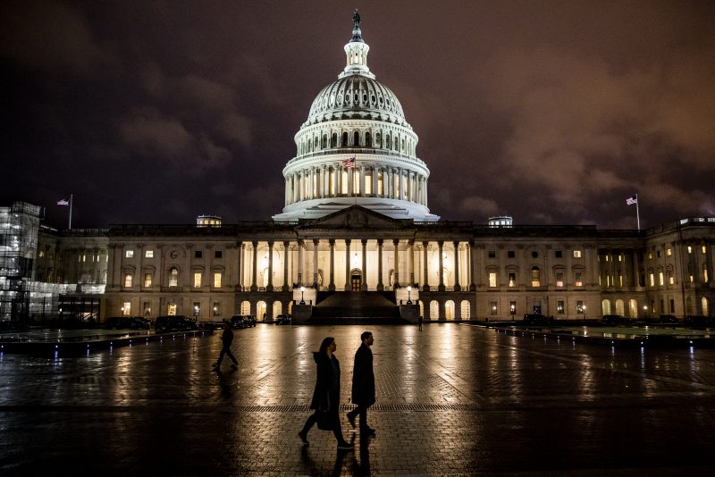 WASHINGTON, DC - DECEMBER 17: People walk along the east front plaza of the US Capitol as night falls on December 17, 2019 in Washington, DC. The House Rules Committee is holding a full committee hearing to set guidelines for the upcoming debate and vote on the two Articles of Impeachment of President Trump in the House of Representatives. (Photo by Samuel Corum/Getty Images)