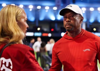 Tiger Woods of Jupiter Links Golf Club talks with his girlfriend, Vanessa Trump, after a match against Boston Common Golf March 17 in Palm Beach Gardens, Florida.