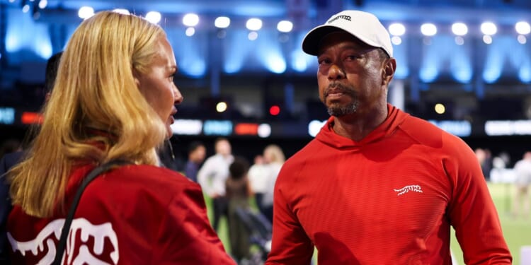 Tiger Woods of Jupiter Links Golf Club talks with his girlfriend, Vanessa Trump, after a match against Boston Common Golf March 17 in Palm Beach Gardens, Florida.