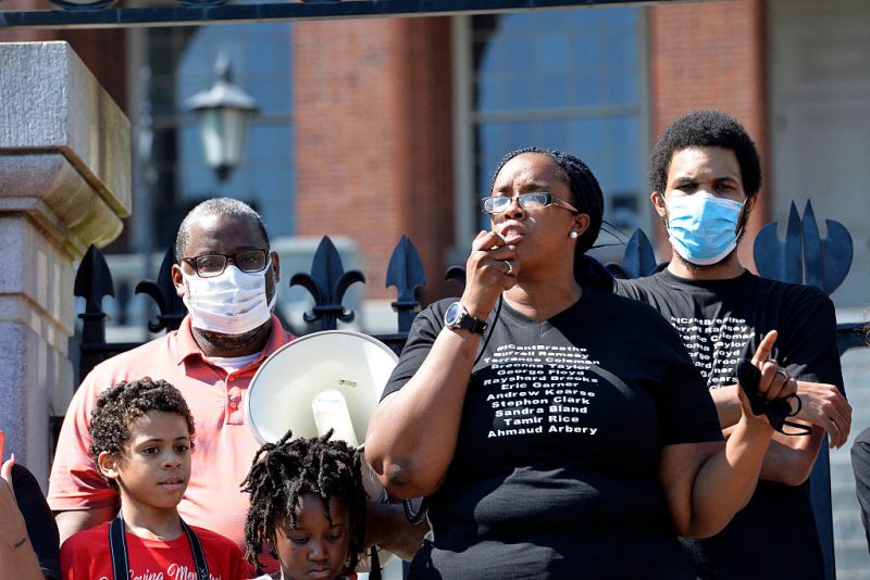 Protesters, including Eric Garner Jr., (R) gather at the State House as Monica Cannon-Grant(C), speaks during a Juneteenth protest and march in honor of Rayshard Brooks and other victims of Police Violence in Boston, Massachusetts on June 22, 2020. (Photo by Joseph Prezioso / AFP via Getty Images)