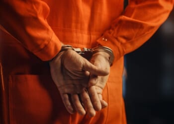 A handcuffed convict before trial.