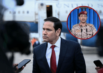 (Background) US Secretary of State Marco Rubio looks on as he speaks to the press following a G7 Foreign Ministers